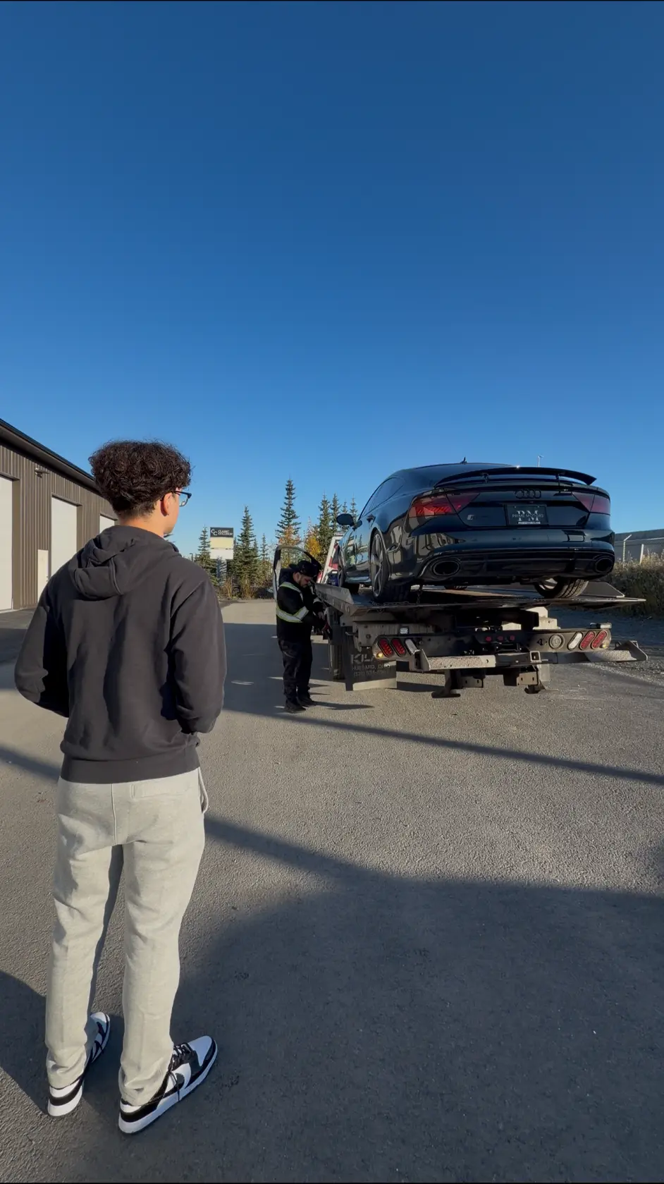 Xavier watching his real RS7 arrive on a delivery truck in Alaska